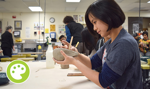 Ceramics student working with clay 